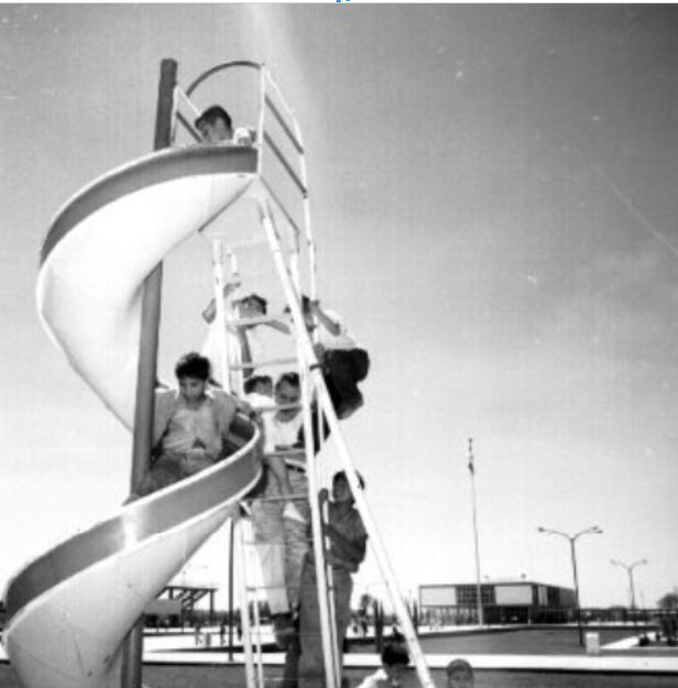 Niños juegan en una resbaladilla, Ca 1955. Nacho López